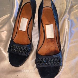 used but in really good condition, black heel with jewels in the front.
